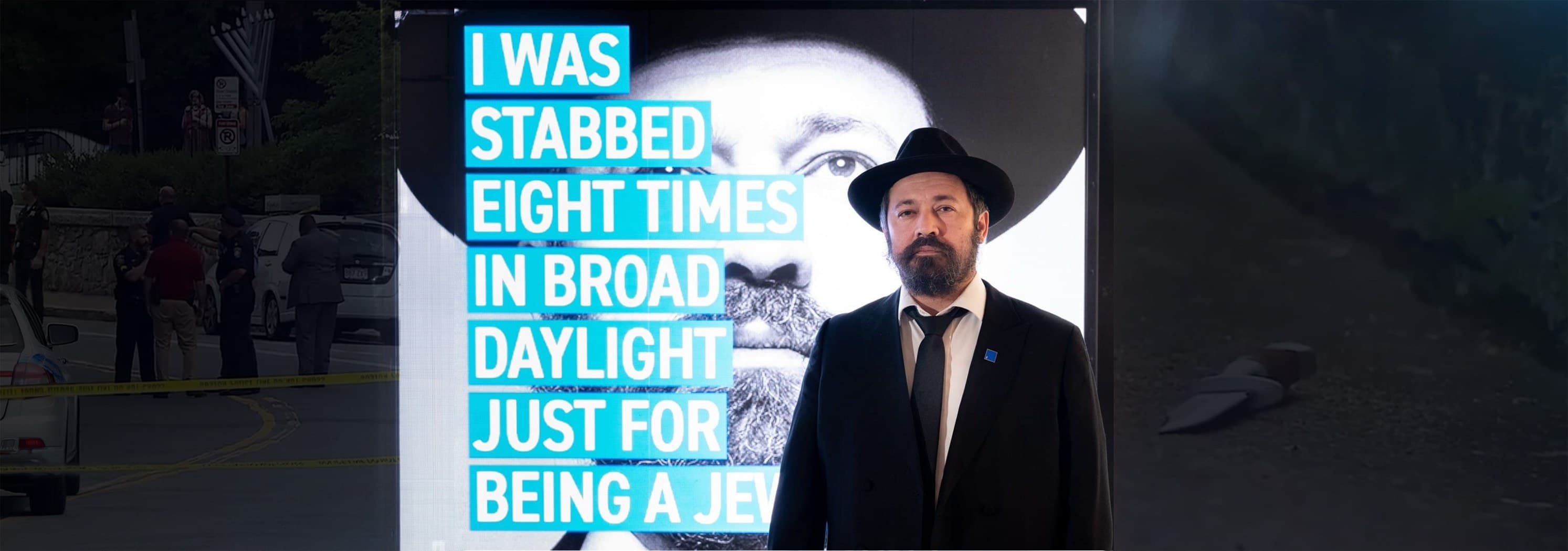 הרב שלמה נוגינסקי לצד תצוגה עם הציטוט שלו על הפיגוע שחווה